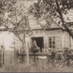 Image of The store and home of Yankev and Perl Rebejkow on a street in Jeziory, ca. 1900.