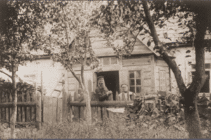 Image of The store and home of Yankev and Perl Rebejkow on a street in Jeziory, ca. 1900.
