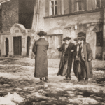 Image of Hasidim outside a house of prayer on Saturday. Cracow, 1938.