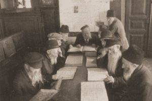 Image of Men studying the Talmud in the bethmedresh of a home for the aged at 17 Portowa Street, Vilna, 1937.
