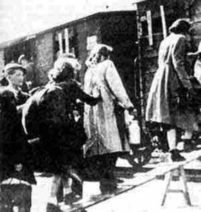 Image of Children boarding box cars to Auschwitz