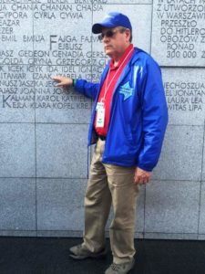 Image of Irv pointing to his Hebrew name Issac inscribed at Umschplatz Warsaw Ghetto Memorial.
