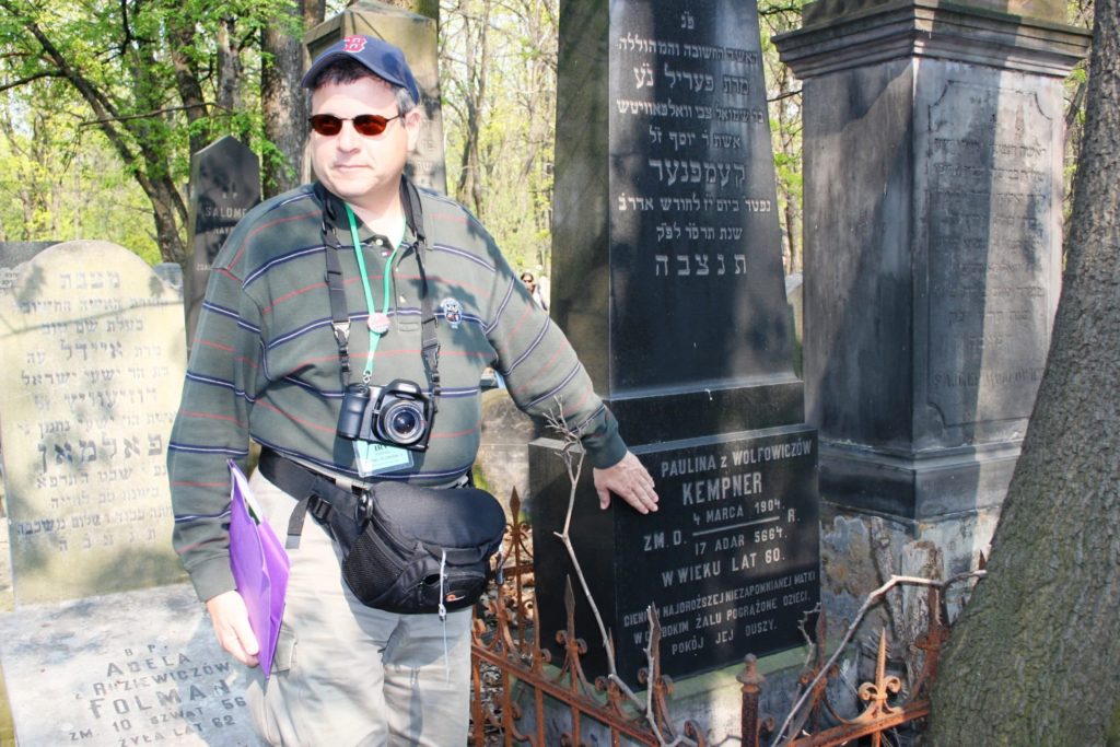 Image of Irv at Warsaw Cemetery headstones of his great grandparents.