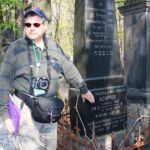 Image of Irv at Warsaw Cemetery headstones of his great grandparents.